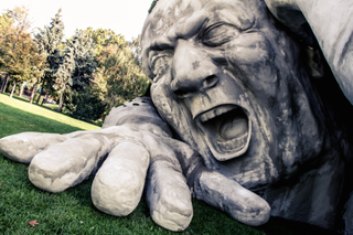 Illustration for article titled Scary giant man crawls out from the ground in shocking outdoor sculpture